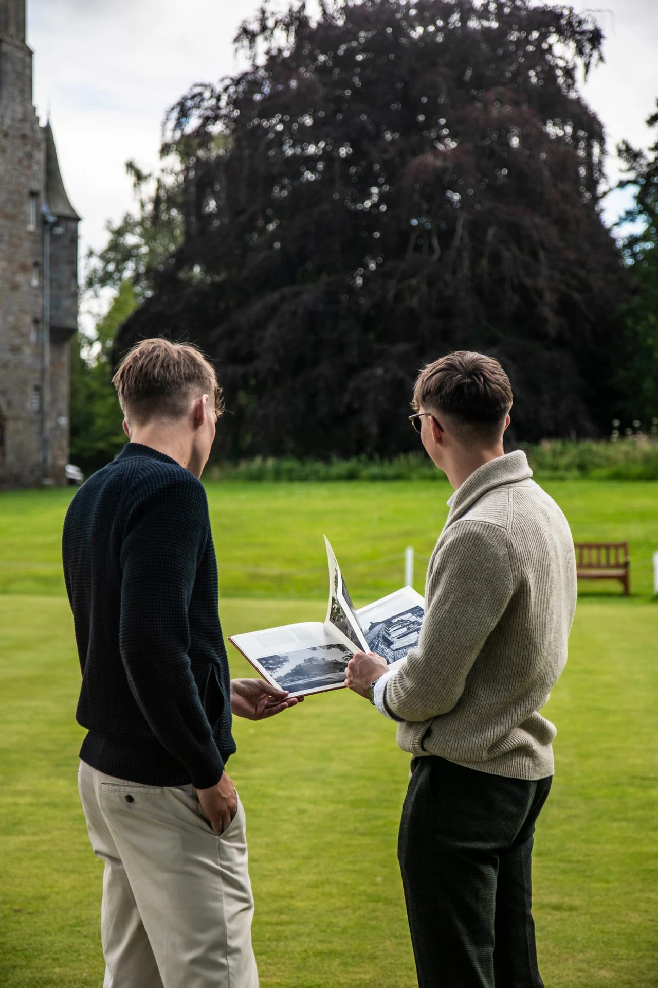 The founders looking through travel inspiration in an estate garden