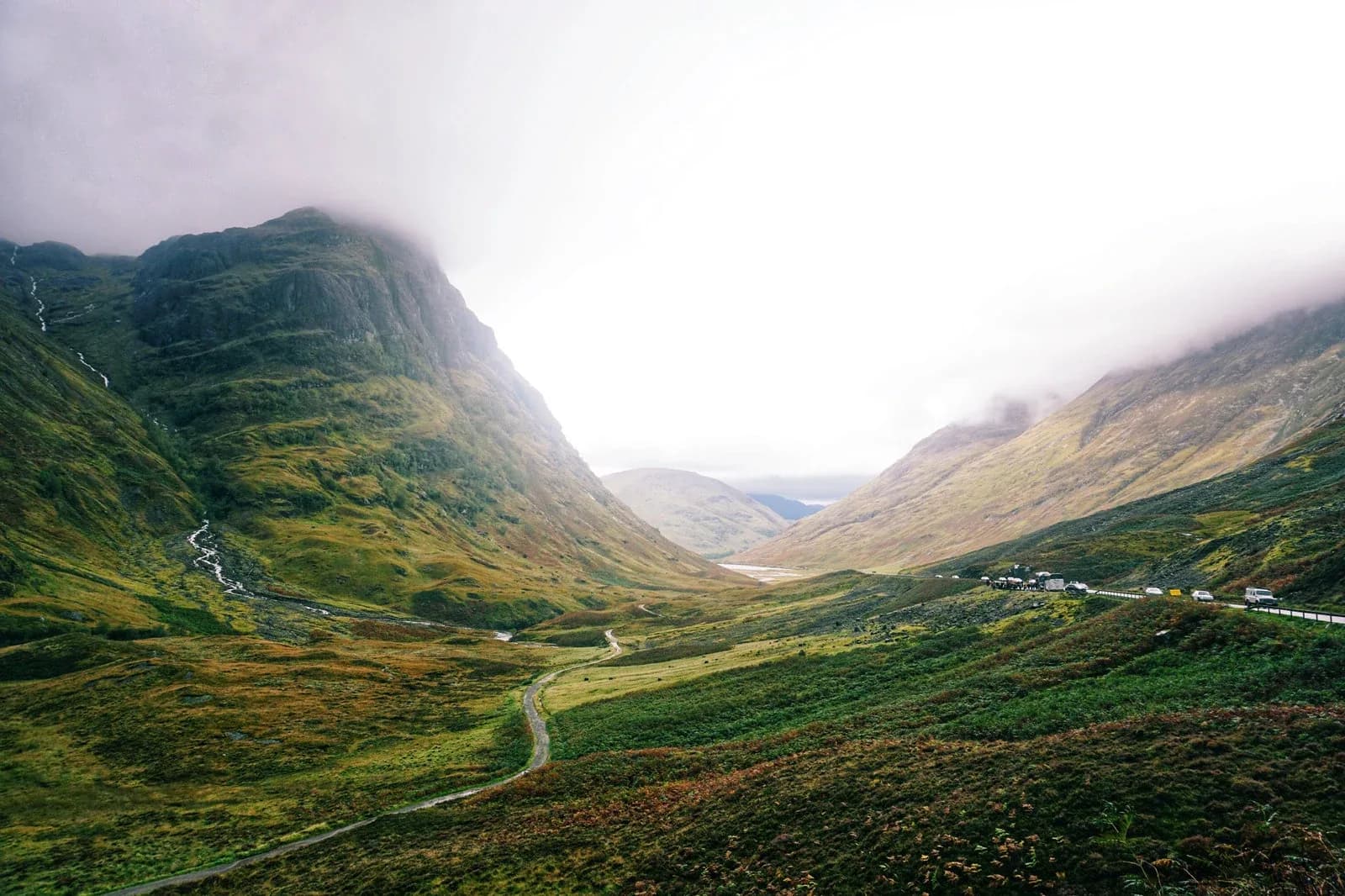Mist hanging over the green slopes and valley of Glencoe