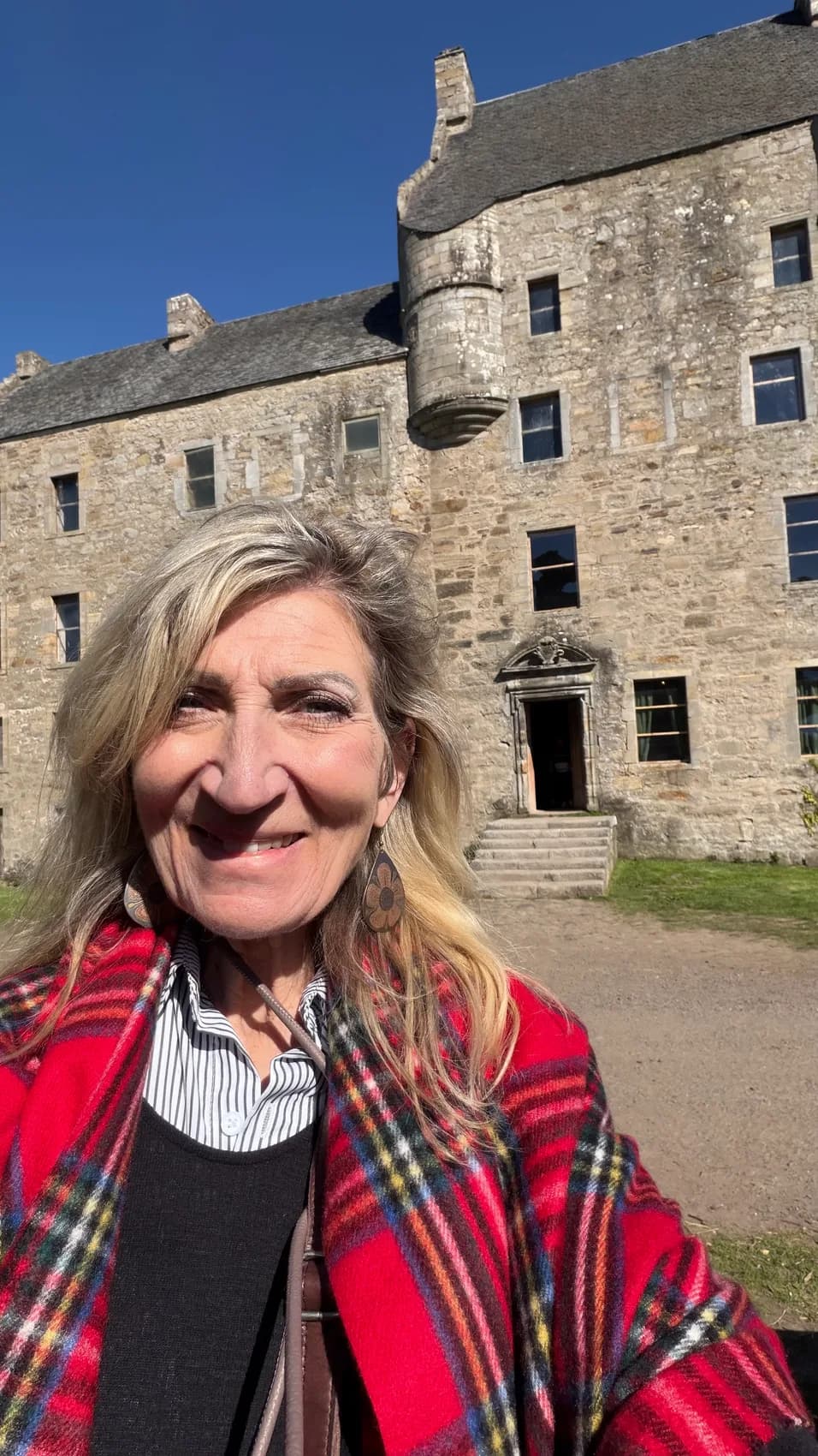 Carol in a tartan scarf outside Midhope Castle
