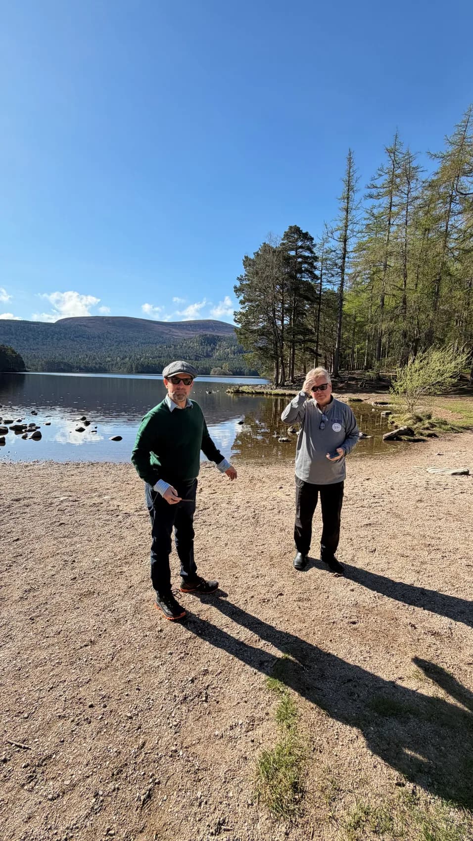 Carol and David beside a loch on a sunny day