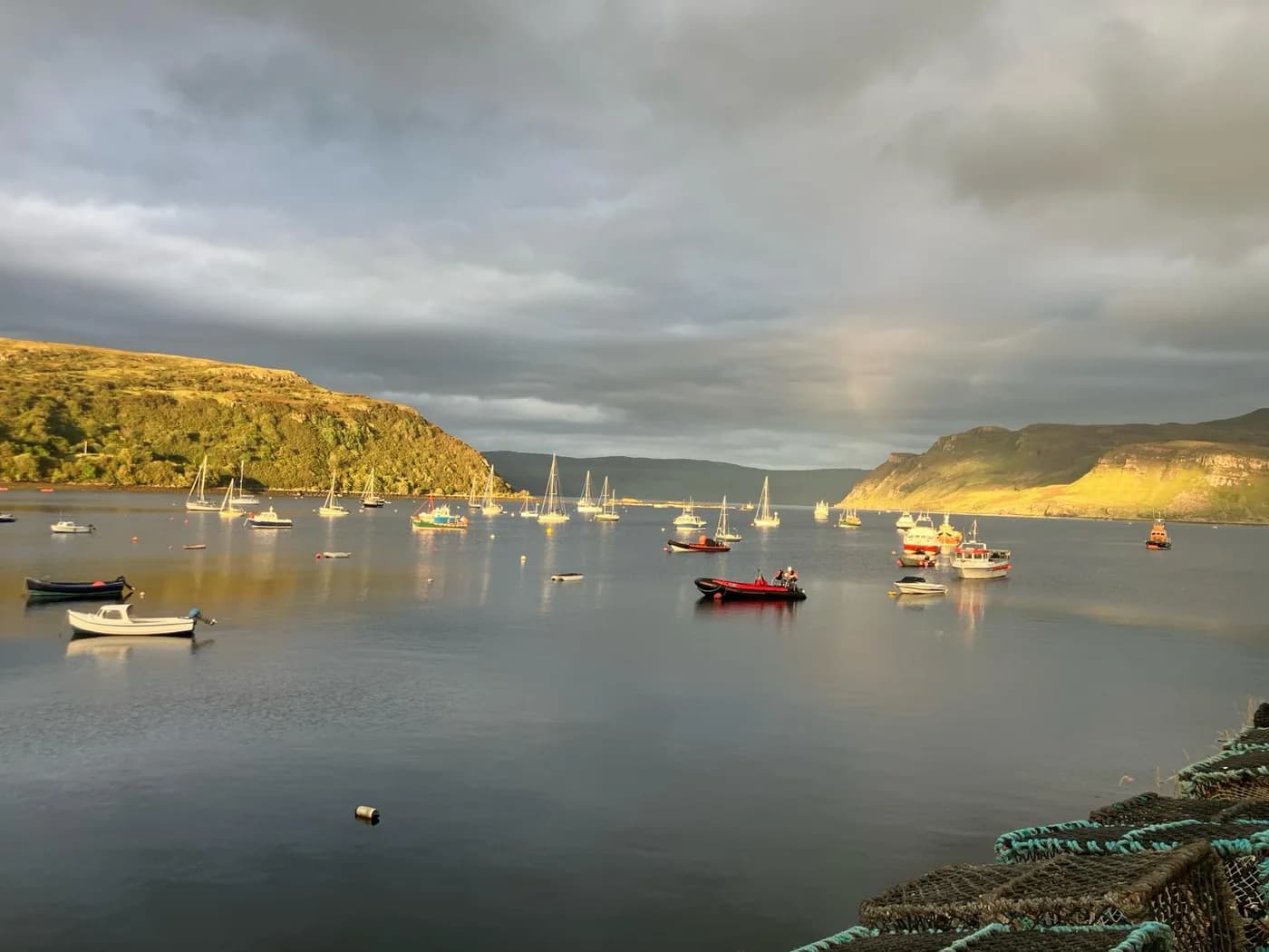 Boats in a sheltered harbour beneath evening light