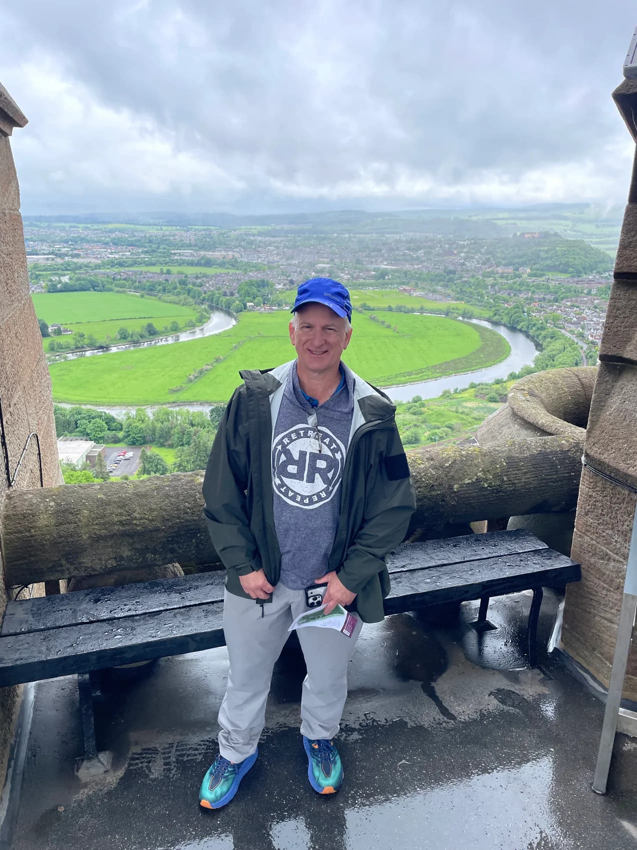 Ed at a stone lookout above the landscape around Stirling