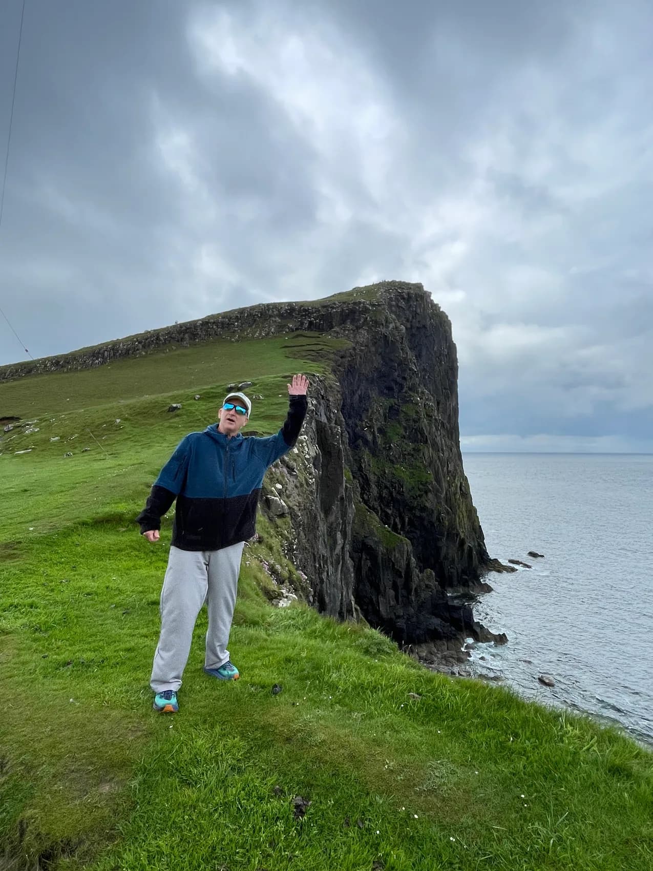 Ed standing above the cliffs and sea on Skye