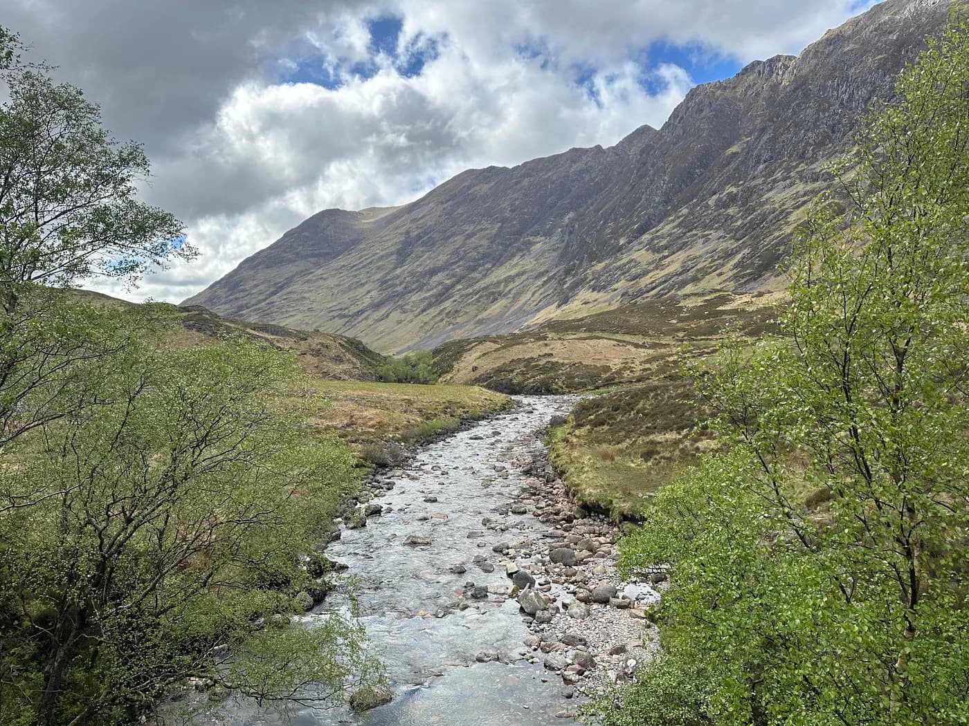 A stream winding between the mountains of Glencoe