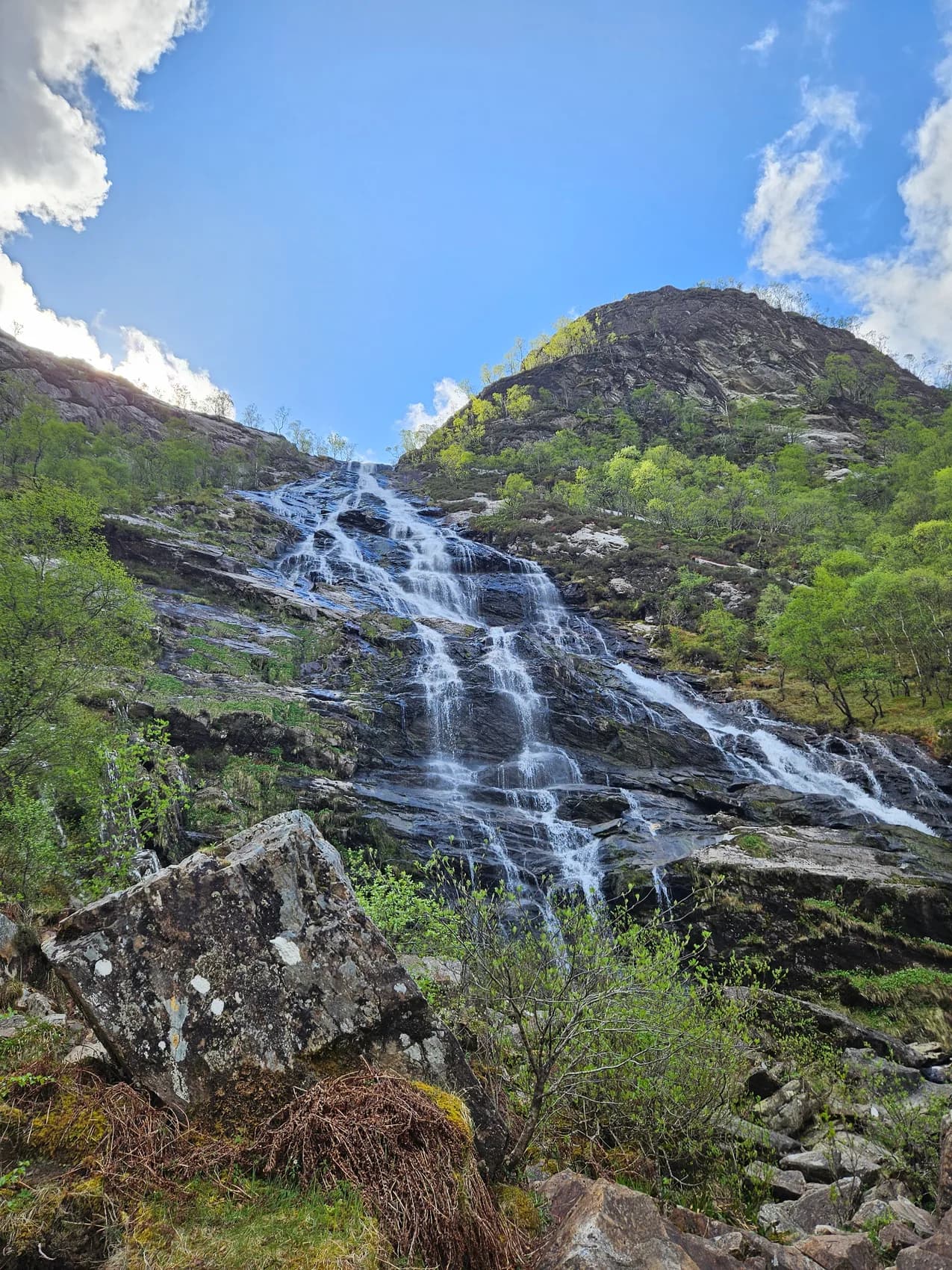 A waterfall cascading down a rocky Highland hillside