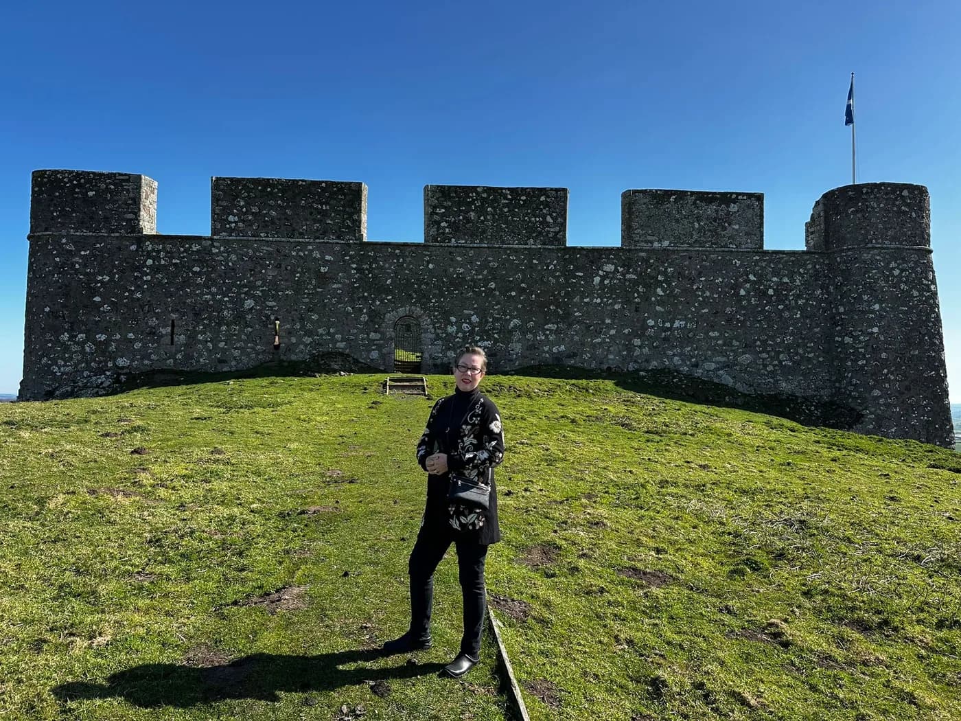 A guest standing beneath the battlements of Hume Castle