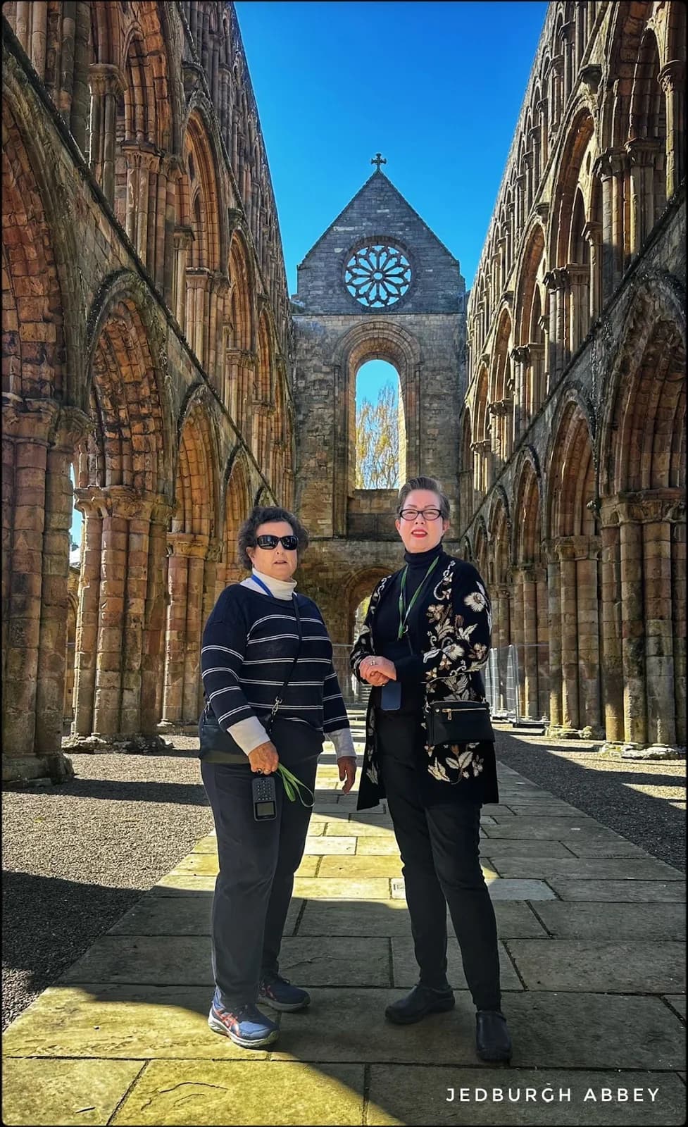 Rebecca and her sister standing within the ruins of Jedburgh Abbey